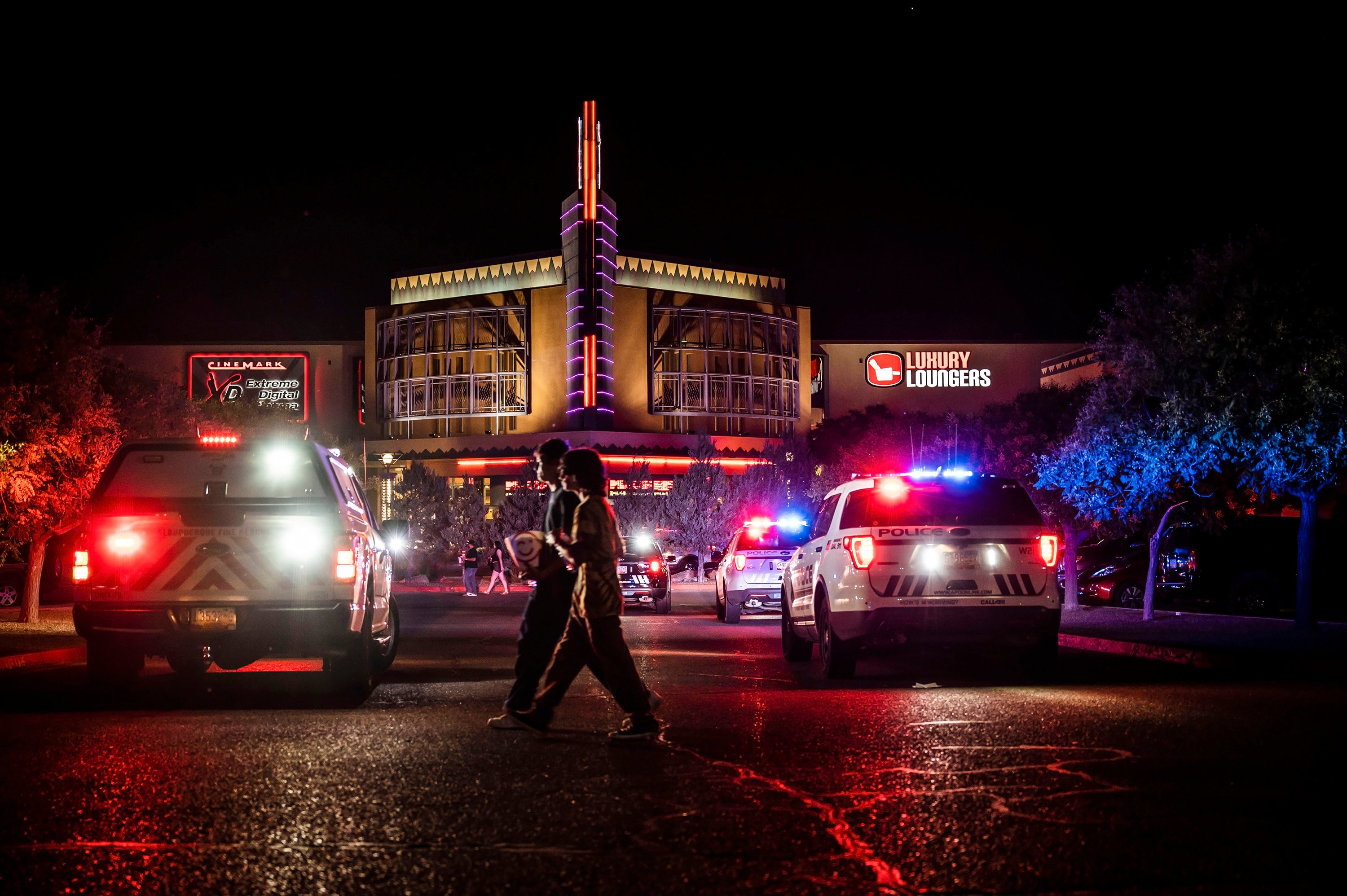 Movie-goers evacuate the Century Rio movie theater as officers respond to a shooting at the theater located at 4901 Pan American freeway in northeast Albuquerque, N.M., on Sunday, June 25, 2023.