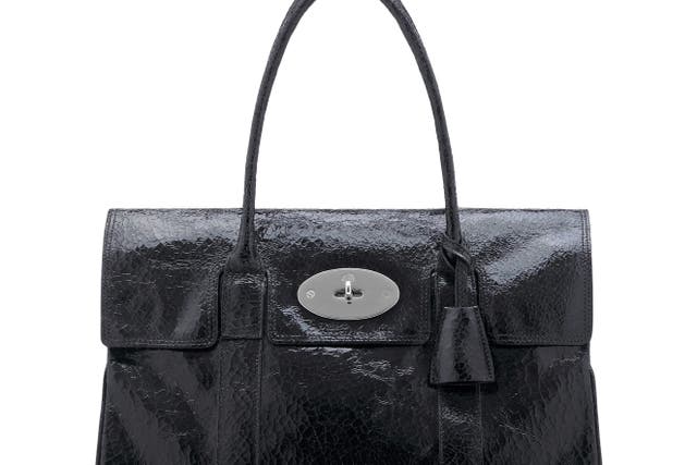 Luxury handbag maker Mulberry has seen its profits slump after higher costs and as UK sales stall amid economic uncertainty and a hit from the loss of VAT-free shopping for tourists.