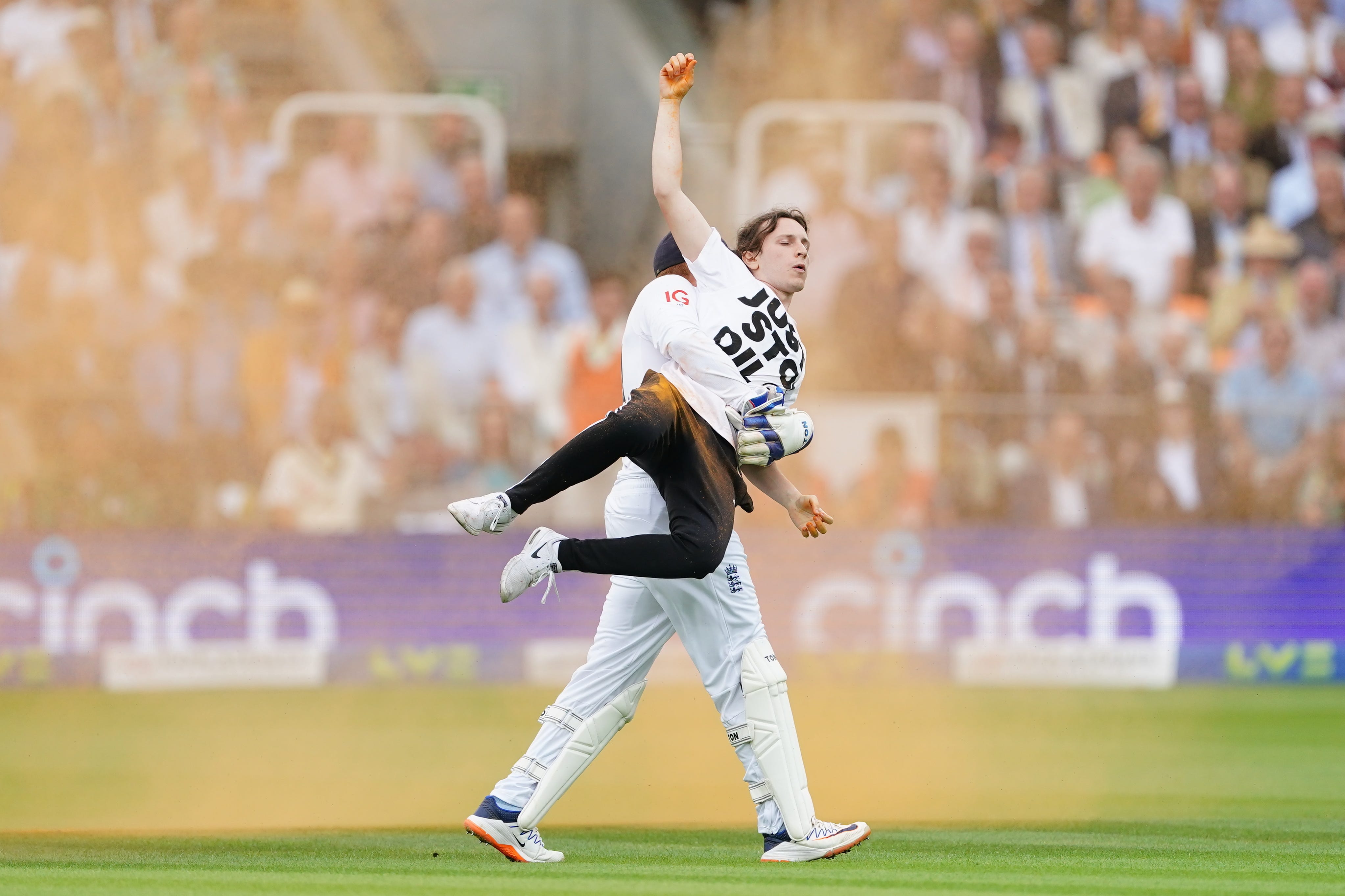 England’s Johnny Bairstow carrying a Just Stop Oil protester off the pitch during day one of the second Ashes test match at Lord’s (Mike Egerton/PA)
