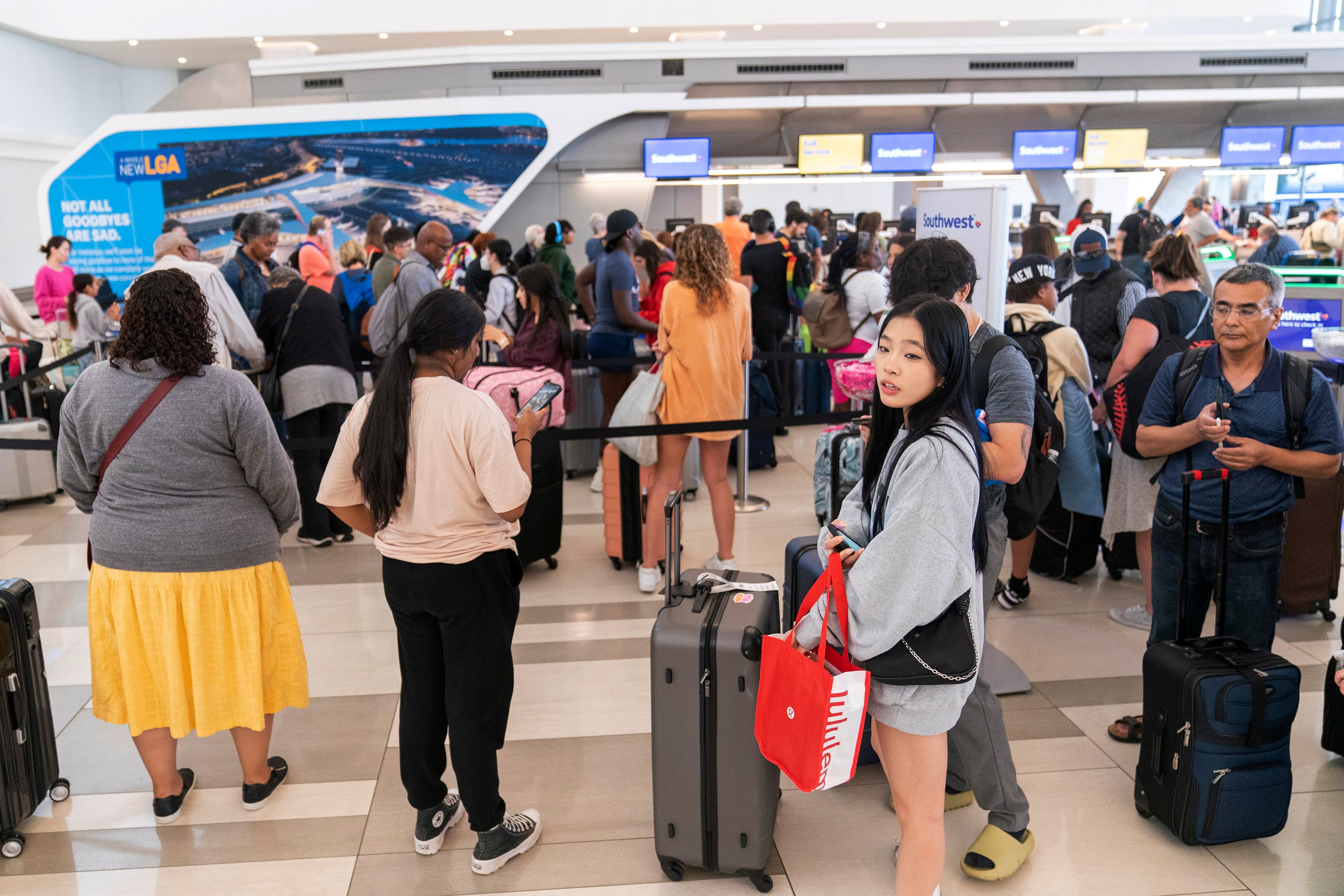 <p>Long lines surround a Southwest ticket counter at LaGuardia Airport </p>