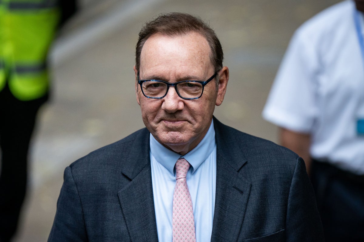 Kevin Spacey smiles as he appears in court for start of sexual assault trial