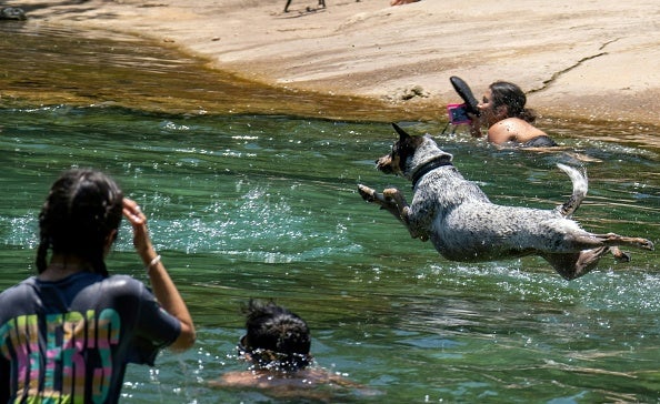 Residents swim at Barton Creek Pool on June 27, 2023 in Austin, Texas