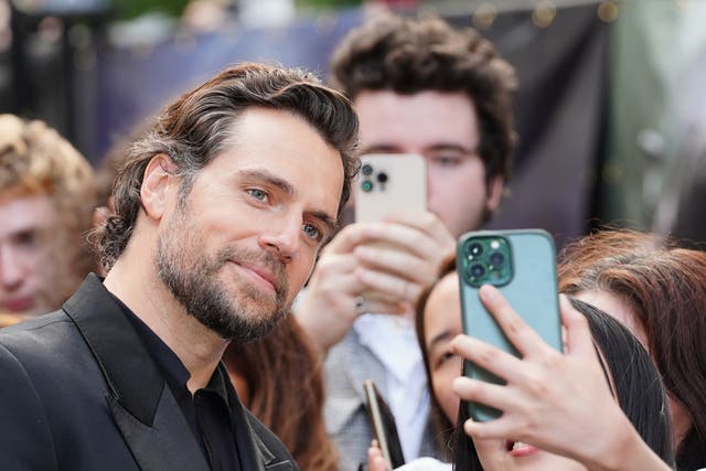 <p>Henry Cavill takes a selfie with a fan as he attends the UK premiere of The Witcher season 3, at the Now Building in London.</p>
