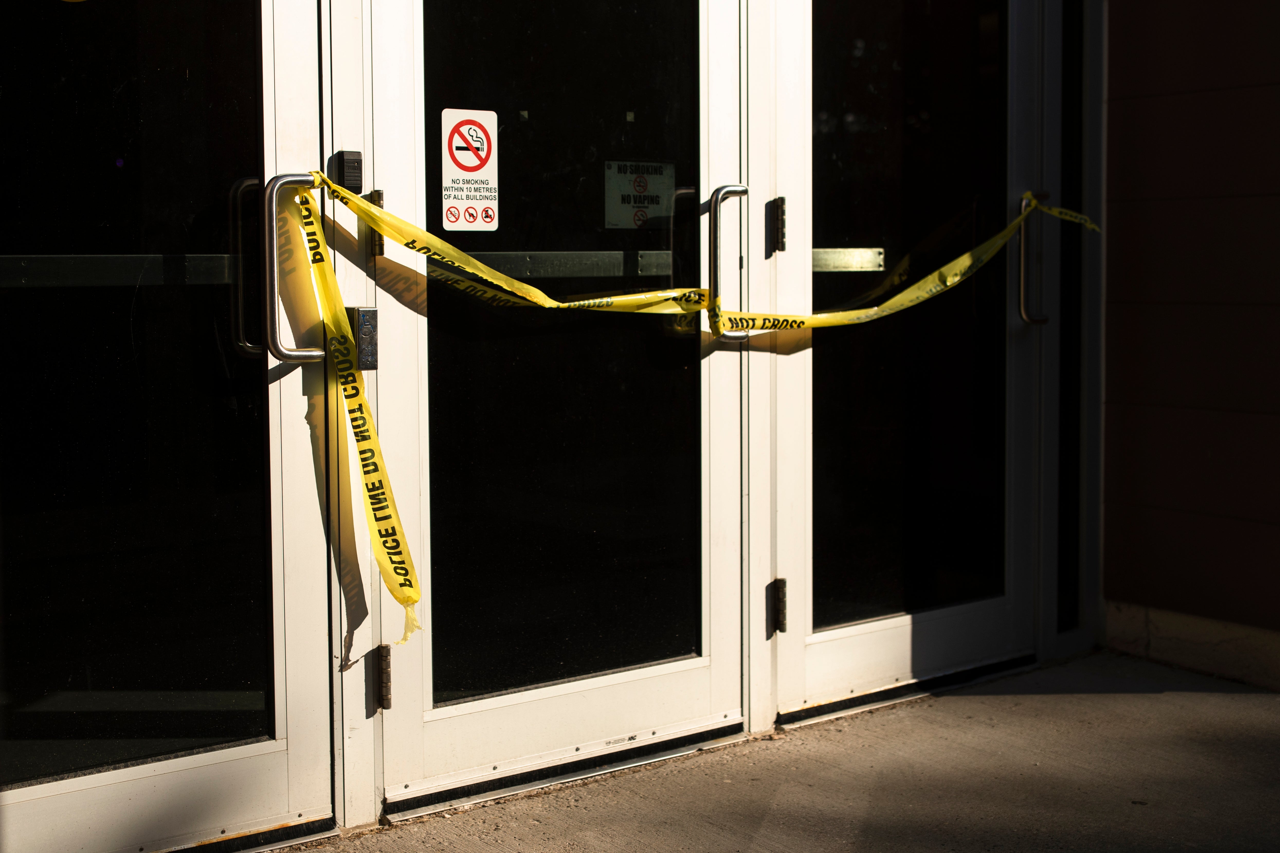 Police tape cordons off a door following a stabbing at the University of Waterloo, in Waterloo, Ontario, Wednesday, June 28, 2023.