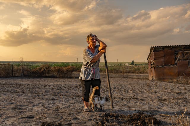 <p>Olha Mosyk stands on her land destroyed by the flood from the exploded dam in Kherson</p>