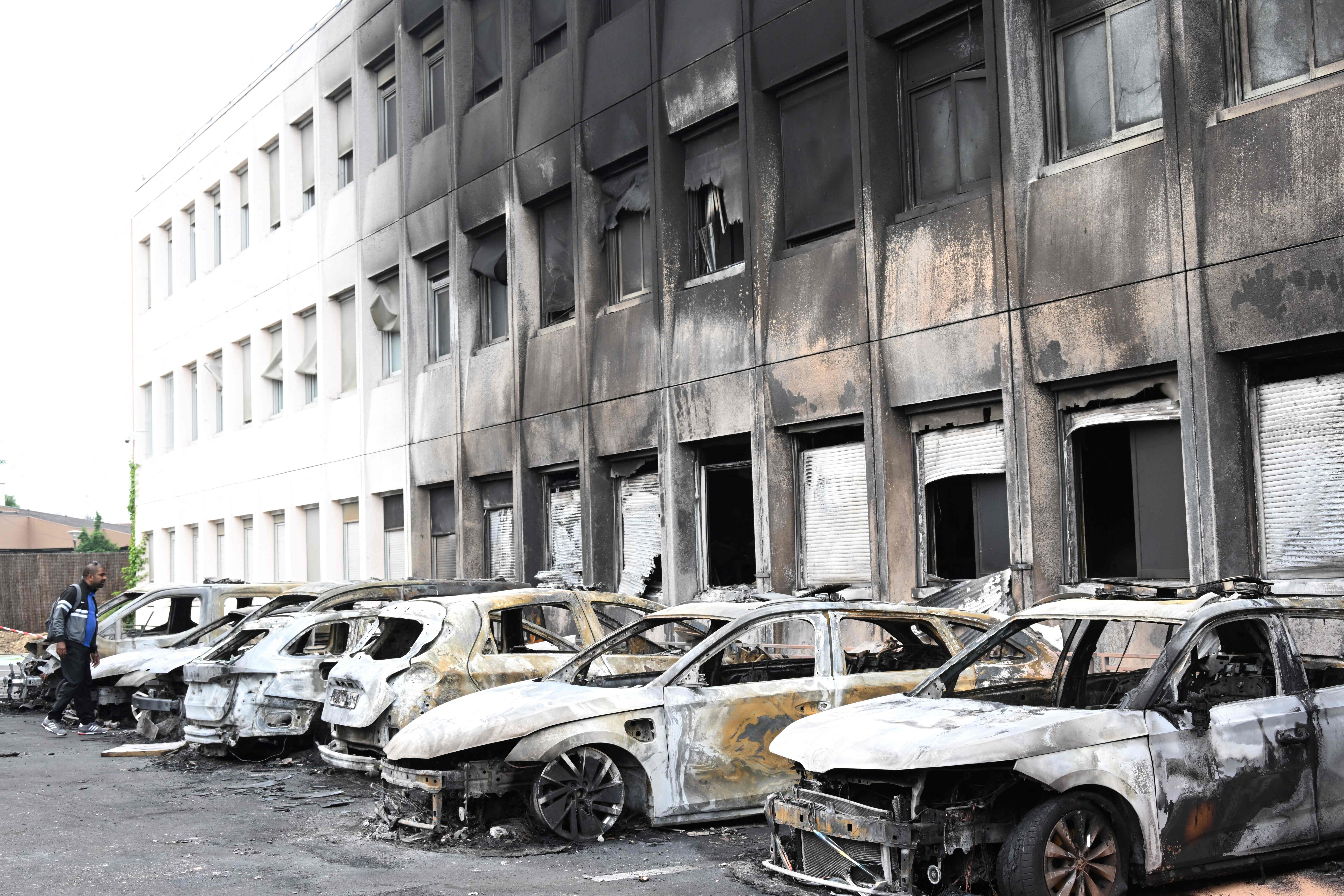 Seven burnt out vehicles are seen outside the municipal police building following violence in Neuilly-sur-Marne on 29 June 2023