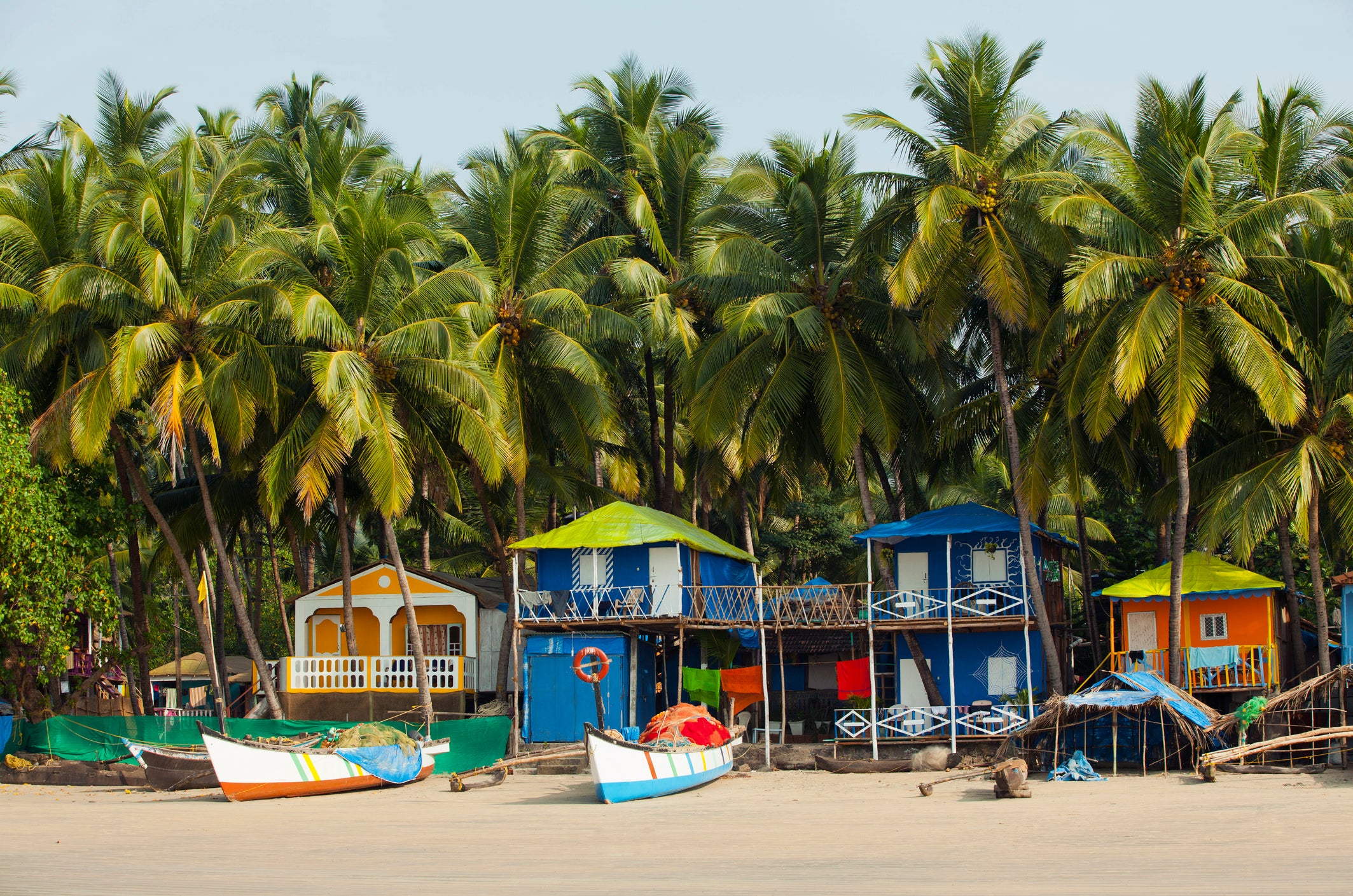 Colourful fishing boats dot Palolem Beach in Goa, South India
