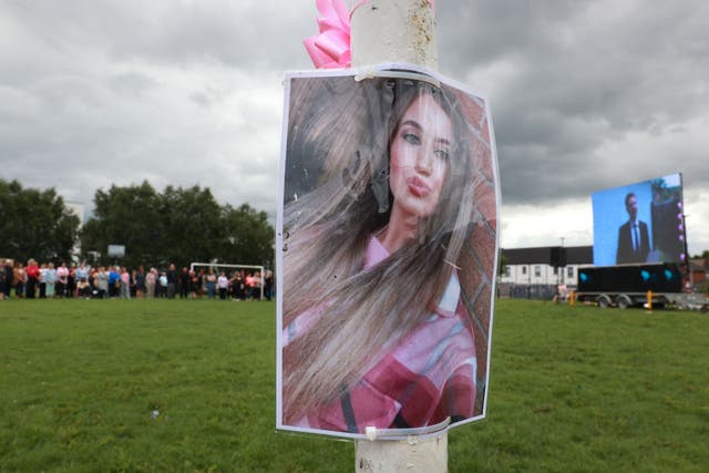 An image of Chloe Mitchell in King George Harryville Park, Ballymena, as members of the public watch her funeral service on a big screen (Liam McBurney/PA)