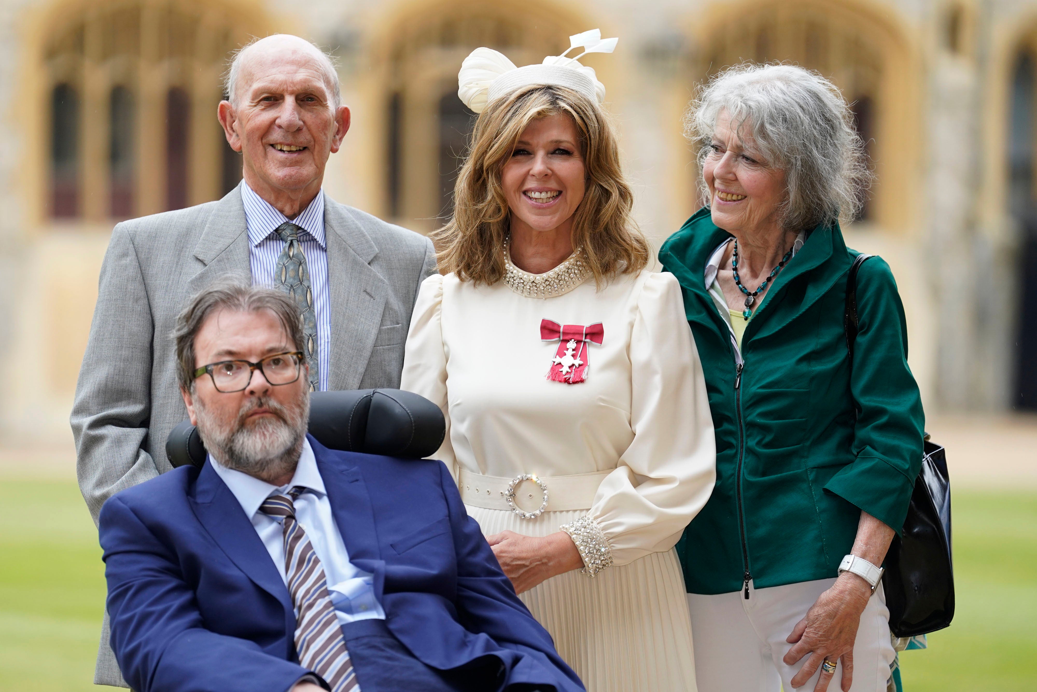 Derek Draper watches as his wife Kate Garraway collects her MBE from Prince William