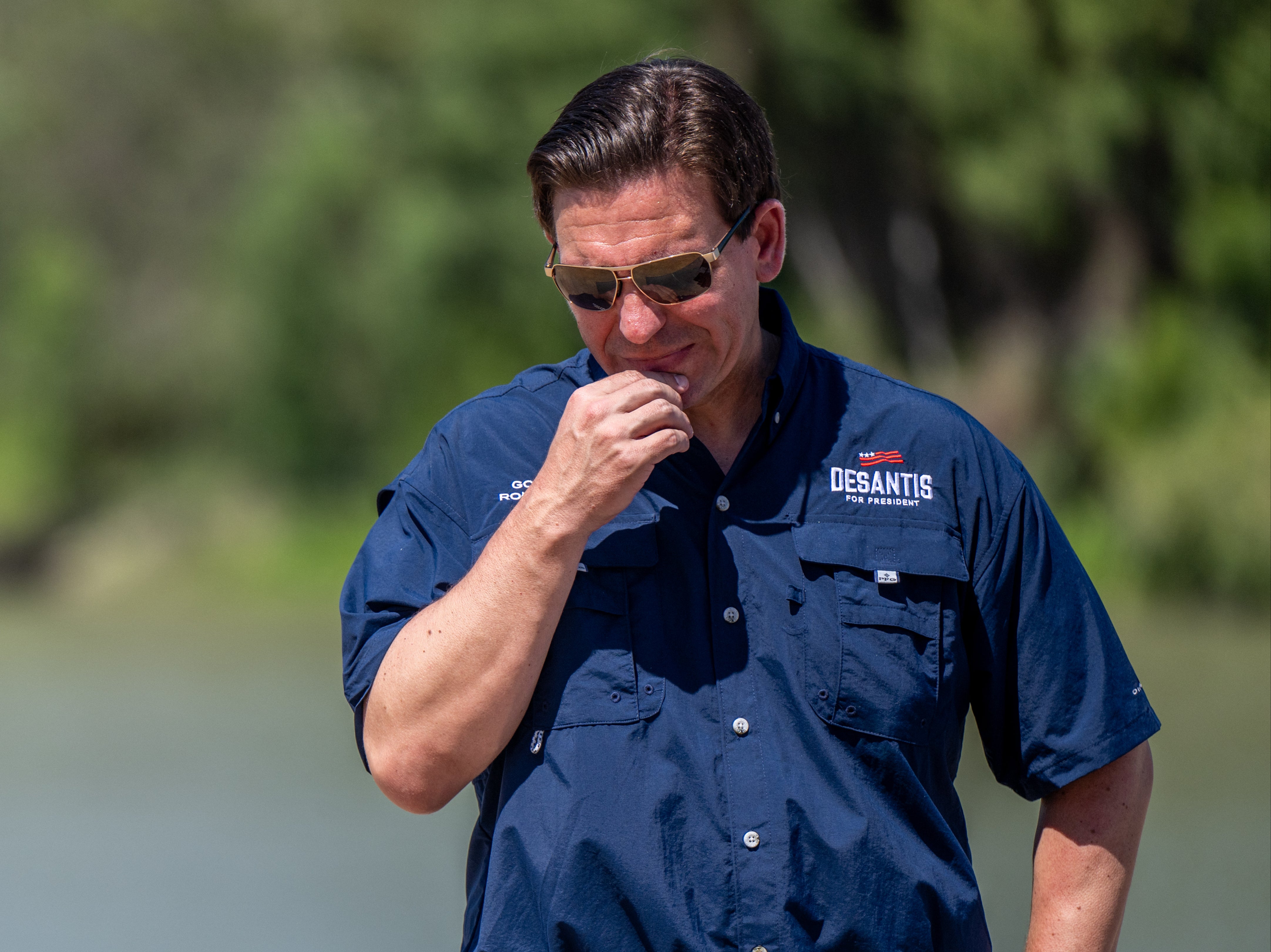 Ron DeSantis stands on the banks of the Rio Grande during a press conference in Eagle Pass, Texas, in June