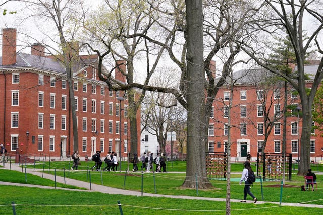 <p>Students walk through Harvard Yard, April 27, 2022, on the campus of Harvard University in Cambridge, Mass</p>