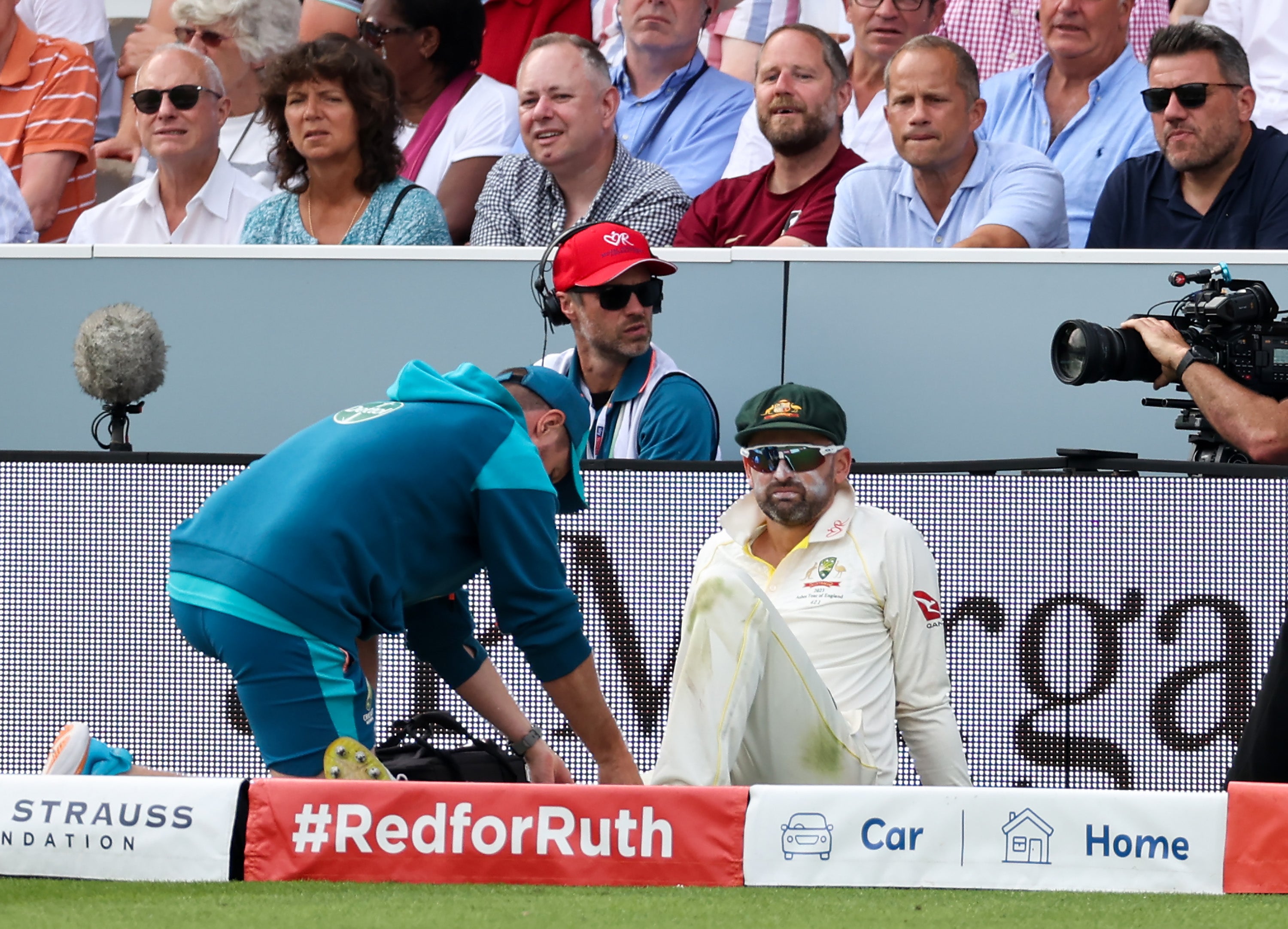 Nathan Lyon leaves the field after picking up an injury in the second test