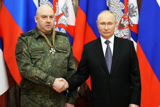 <p>Russian President Vladimir Putin awards a medal to General Sergei Surovikin last December</p>