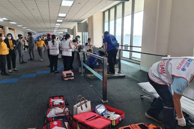 <p>Image shared by Don Mueang International Airport-DMK on Facebook showing the medical staff trying to assist the 57-year-old woman whose leg got stuck in the moving walkway</p>