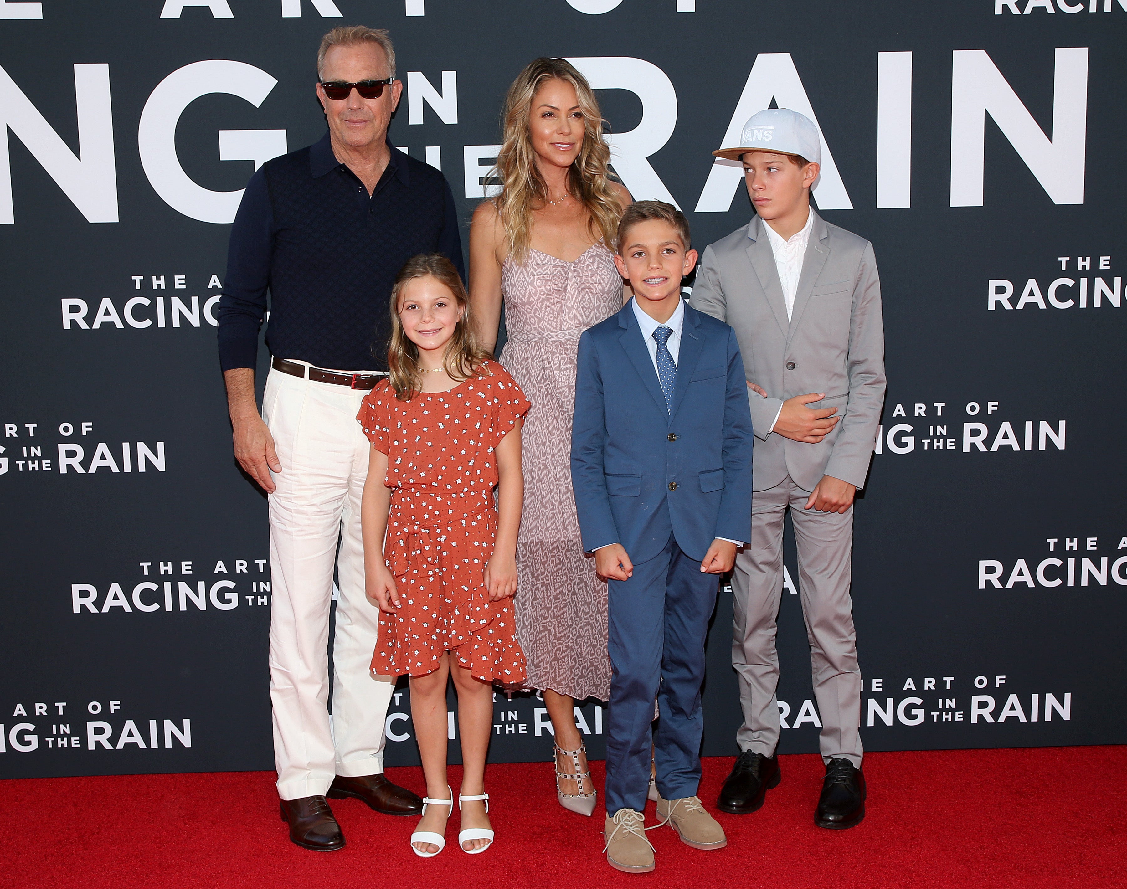 Kevin Costner and Christine Baumgartner attends the Premiere Of 20th Century Fox's "The Art Of Racing In The Rain" at El Capitan Theatre on August 01, 2019