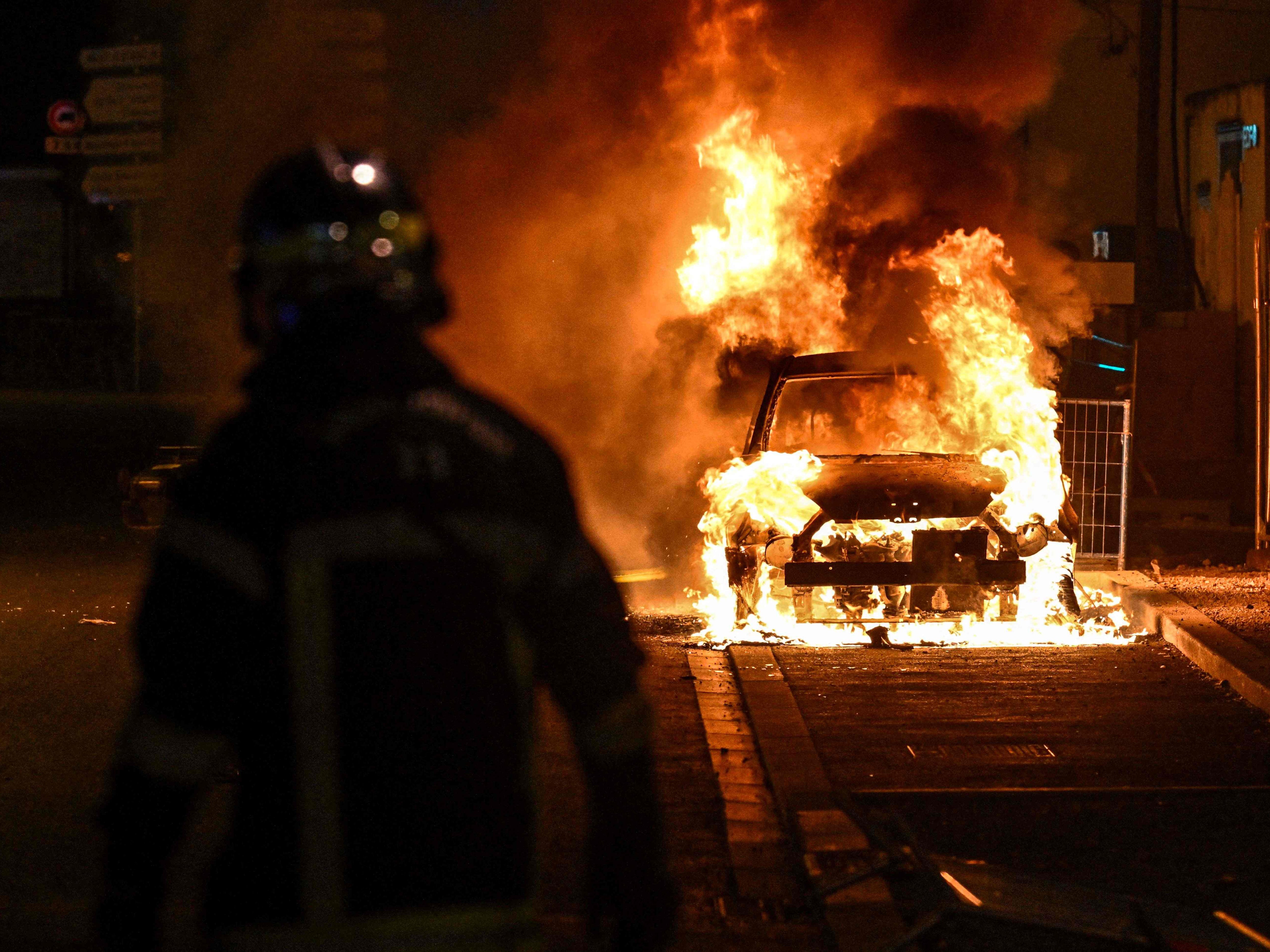 A flaming car during the clashes overnight