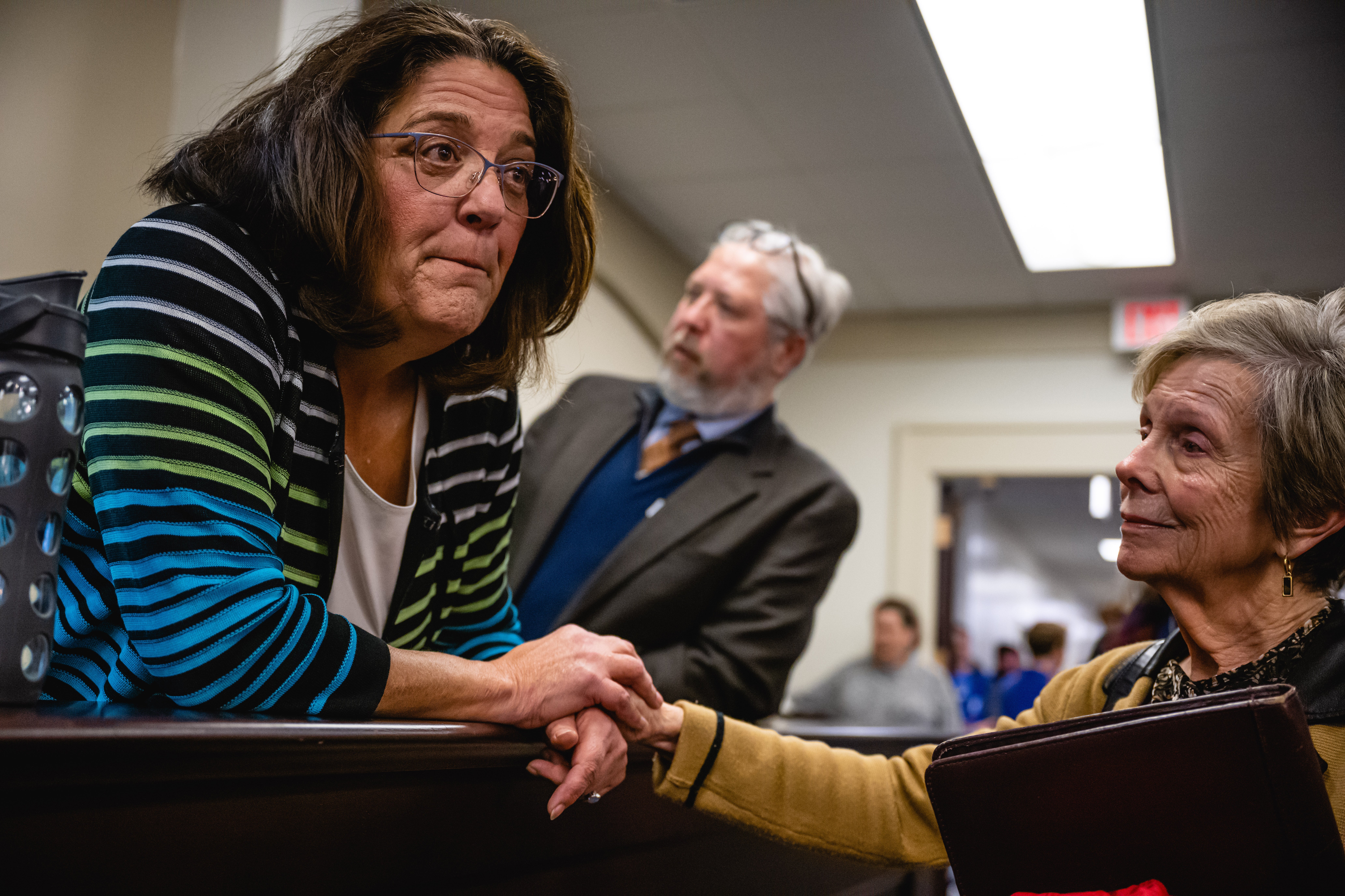 Kentucky state Senator Karen Berg, left, speaks with colleagues in supporters at the capitol in Frankfort following debate over sweeping anti-trans legislation on 14 March.