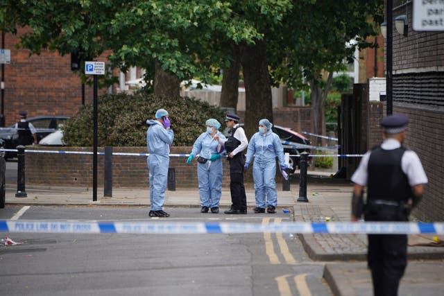 Forensic officers carry out investigations in Elthorne Road, Islington (Lucy North/PA)