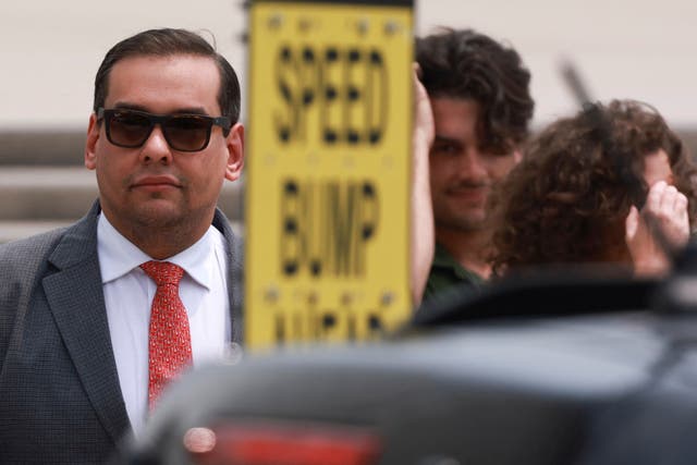 <p>US Representative George Santos looks on outside the Central Islip Federal Courthouse on the day of his hearing, in Central Islip, New York</p>