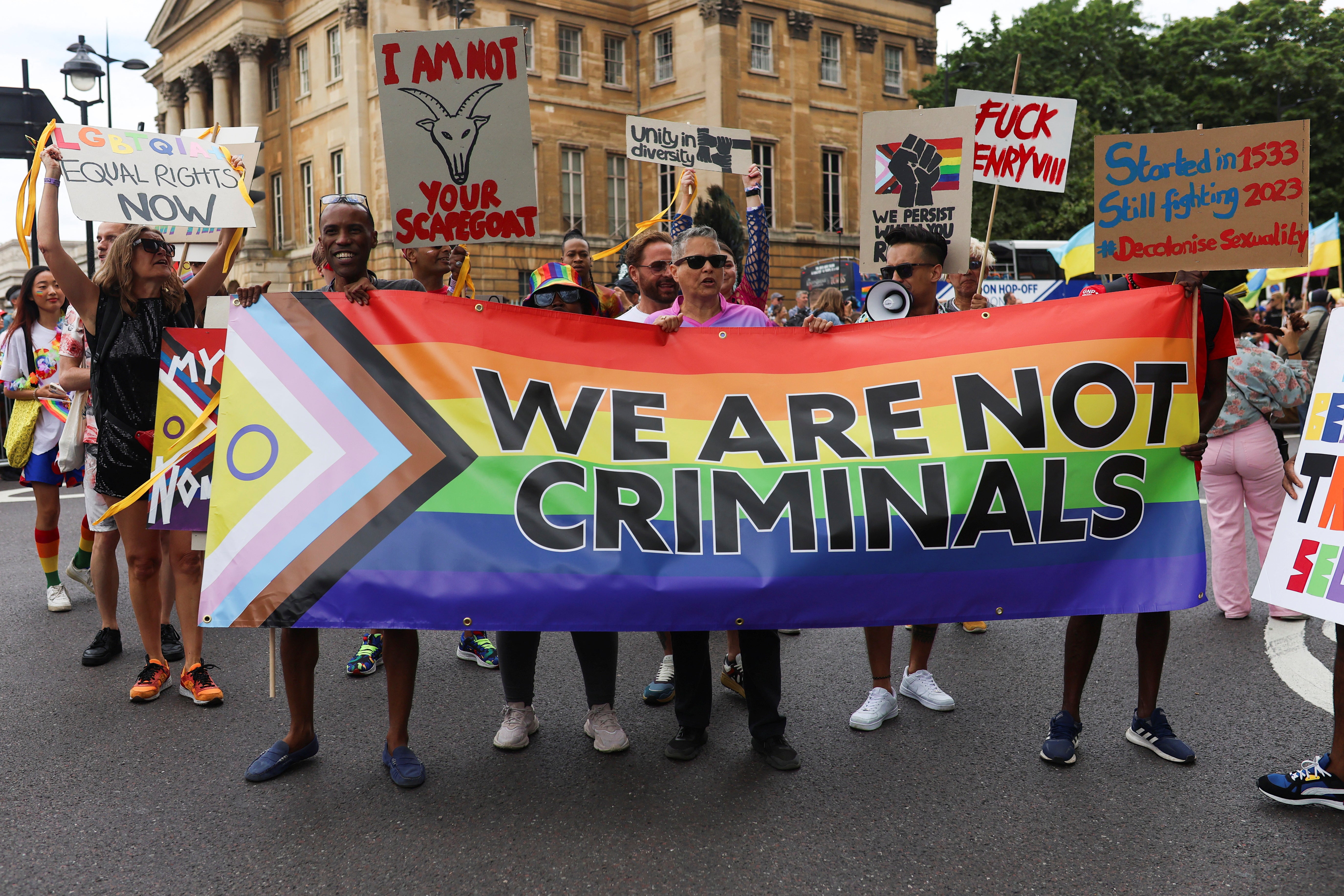 People carry a banner during the 2023 Pride Parade in London