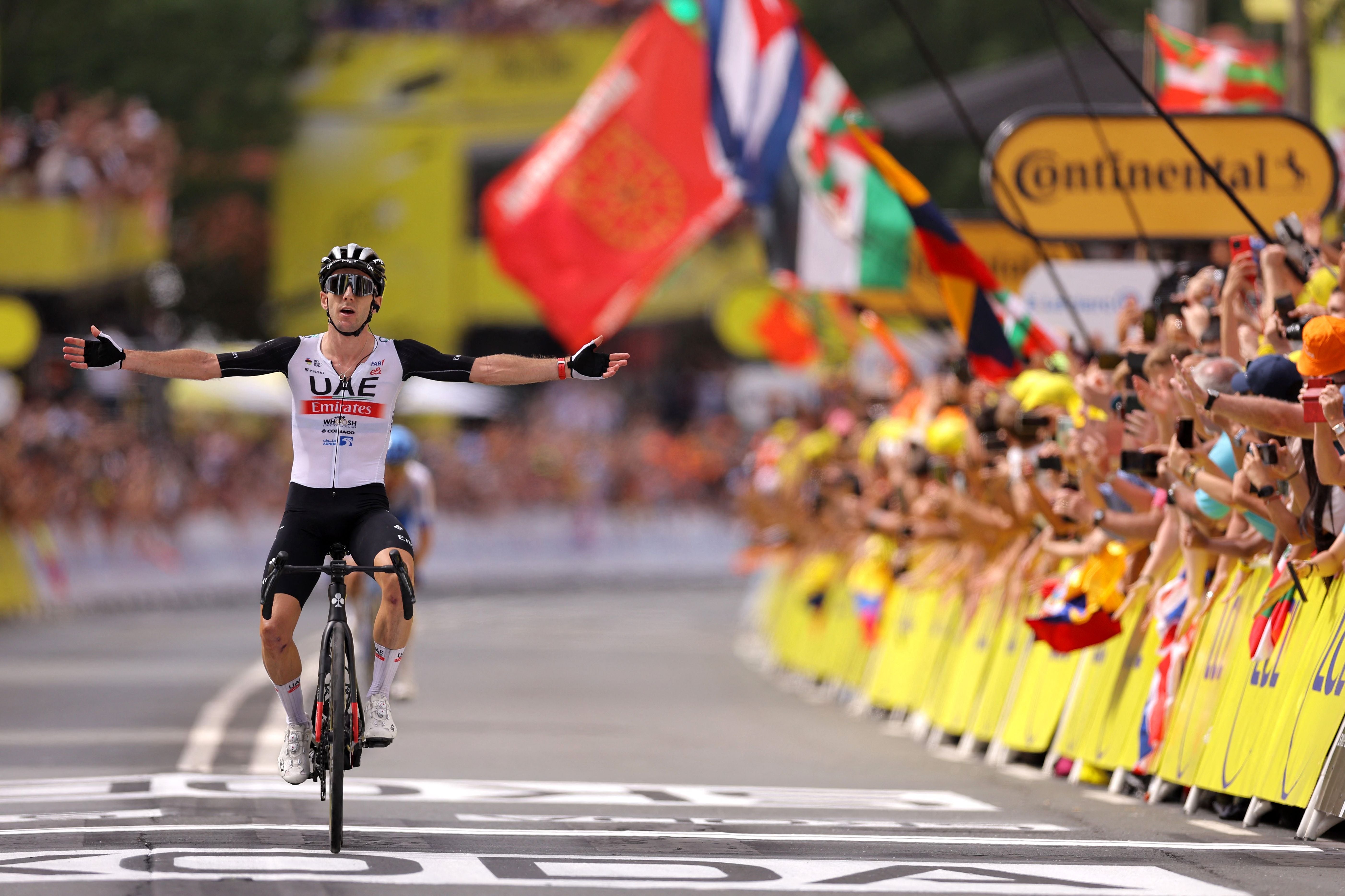 Adam Yates celebrates as he wins stage one of the Tour de France