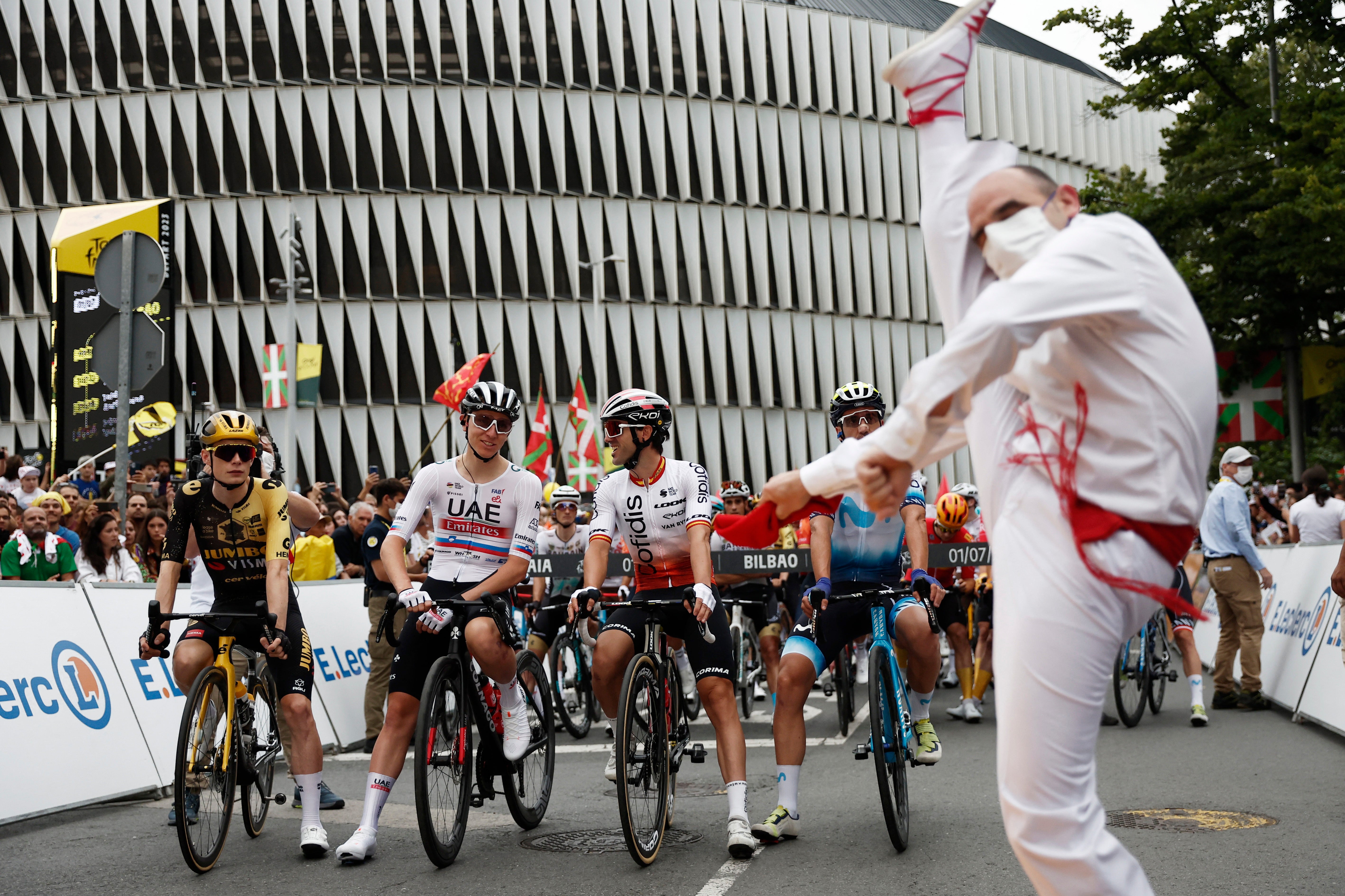 A dancer performs before the start of the Tour de France