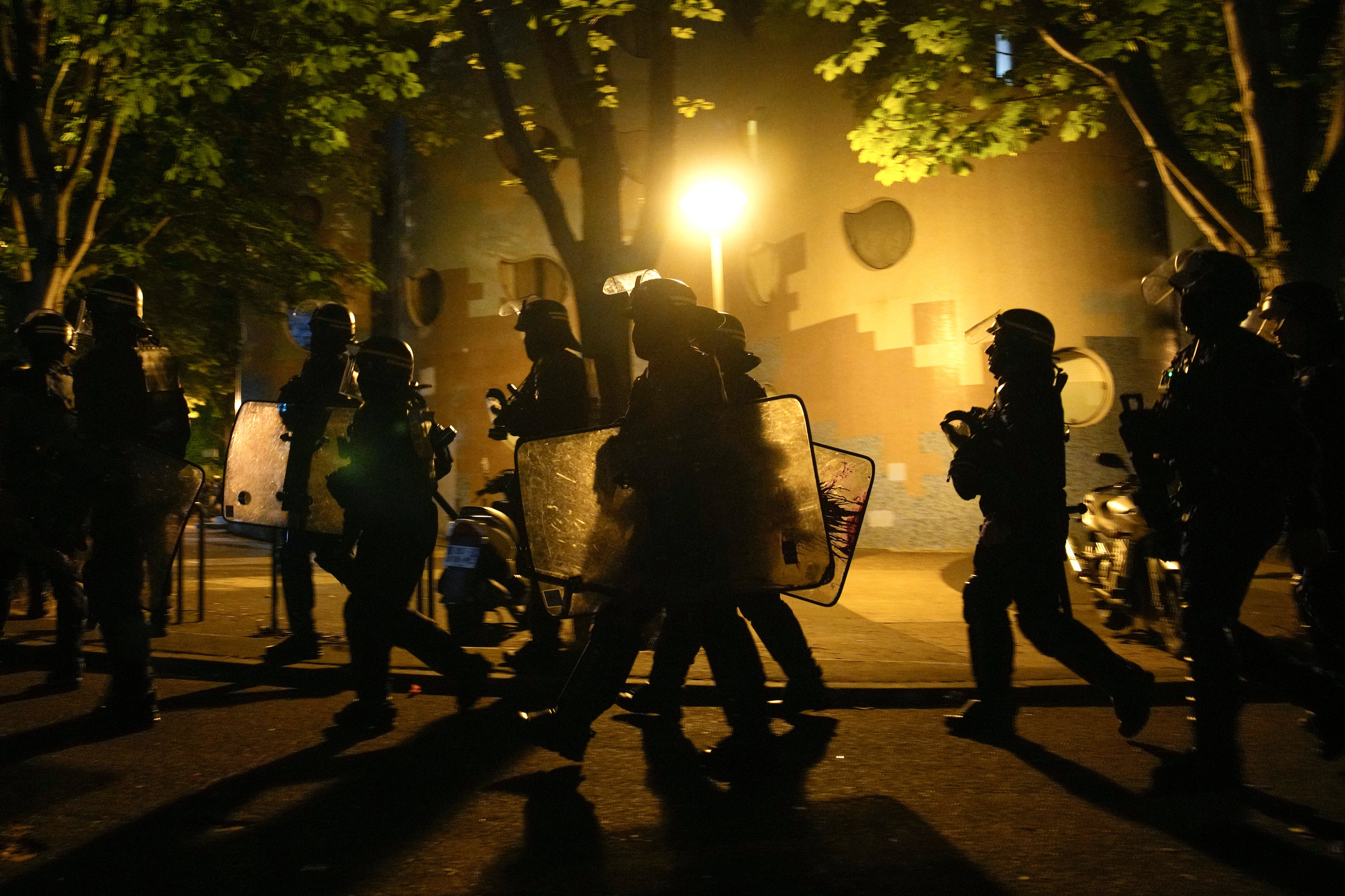 A group of police officers walk during a protest in Nanterre, outside Paris on Saturday