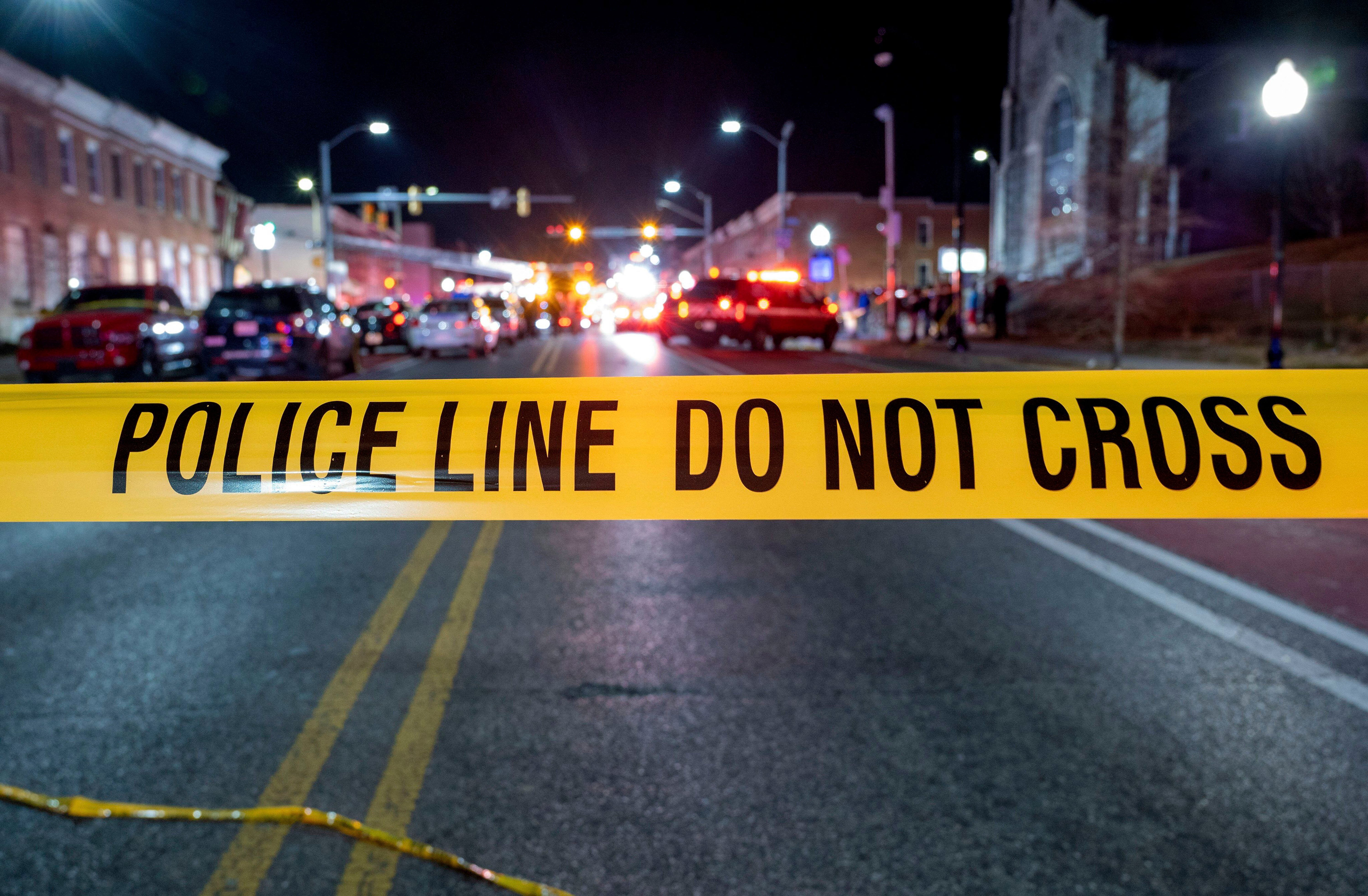 Police tape cordons off the area of a mass shooting incident in the Southern District of Baltimore, Maryland