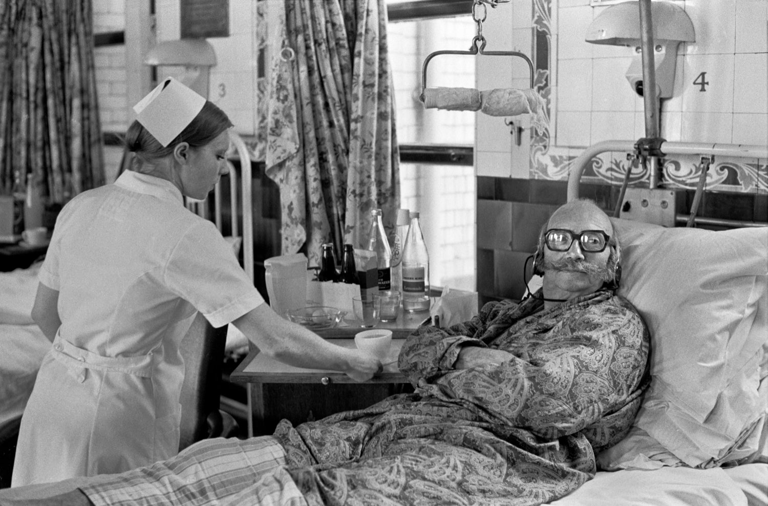 Patient in Charing Cross Hospital watches TV with headphones, 1972