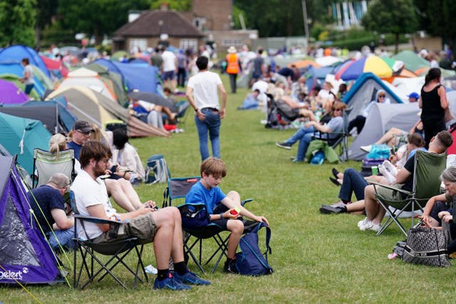 Spectators queue outside at the All England Lawn Tennis and Croquet Club in Wimbledon (Zac Goodwin/PA)