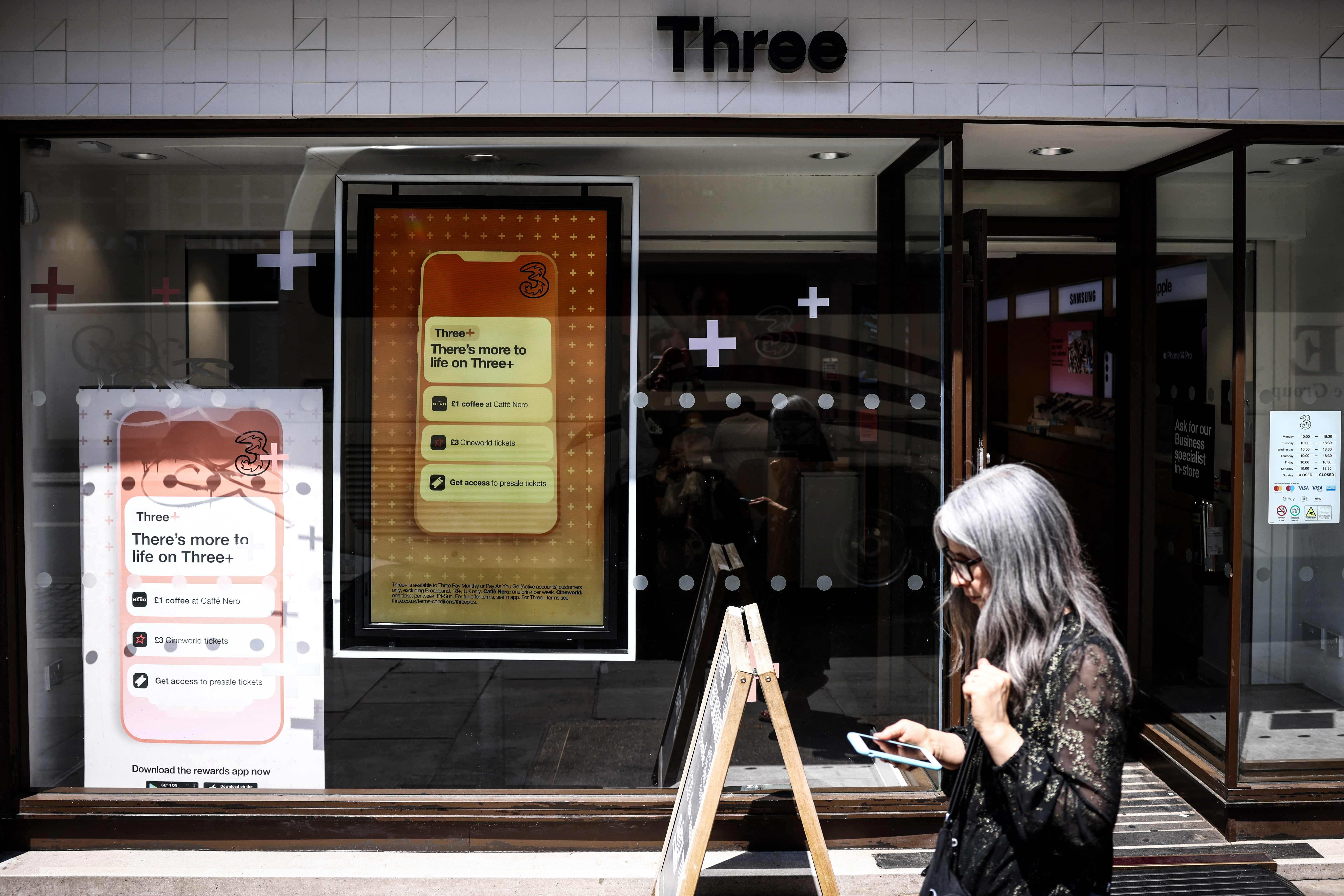A pedestrian walks past a Three UK mobile phone shop, in central London, on June 14, 2023