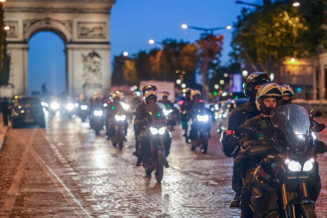 <p>Riot police forces on motorbike secure the area in front of the Arc de triomphe amid fears of another night of clashes</p>
