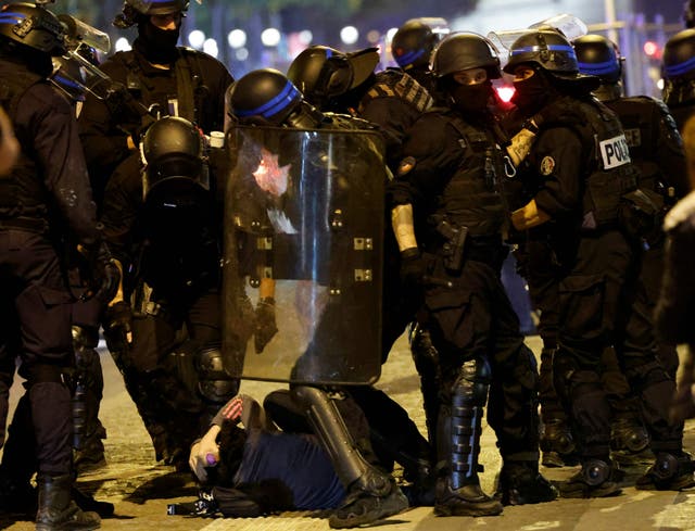 <p>French police officers detain a demonstrator in Paris </p>