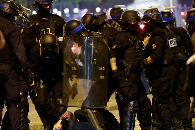<p>French police officers detain a demonstrator in Paris </p>
