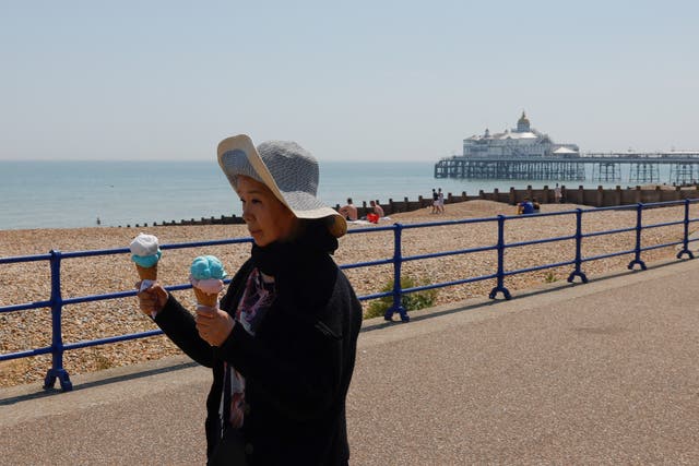 <p>A person seen holding ice creams in Eastbourne, Britain on 10 June</p>