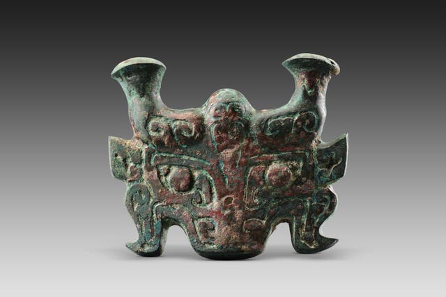 <p>A bronze component of a carriage in the shape of a beast face discovered in tombs of the Zhaigou site, Qingjian county, Yulin, Shaanxi province</p>