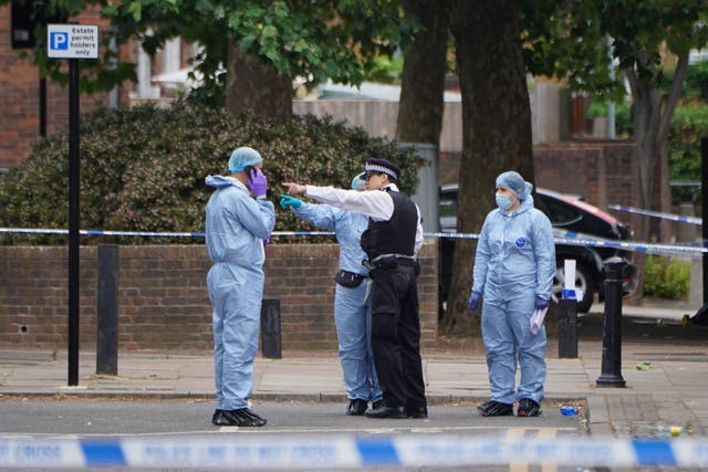 Forensic officers in Elthorne Road, Islington, after a man and a teenager were stabbed to death (Lucy North/PA)