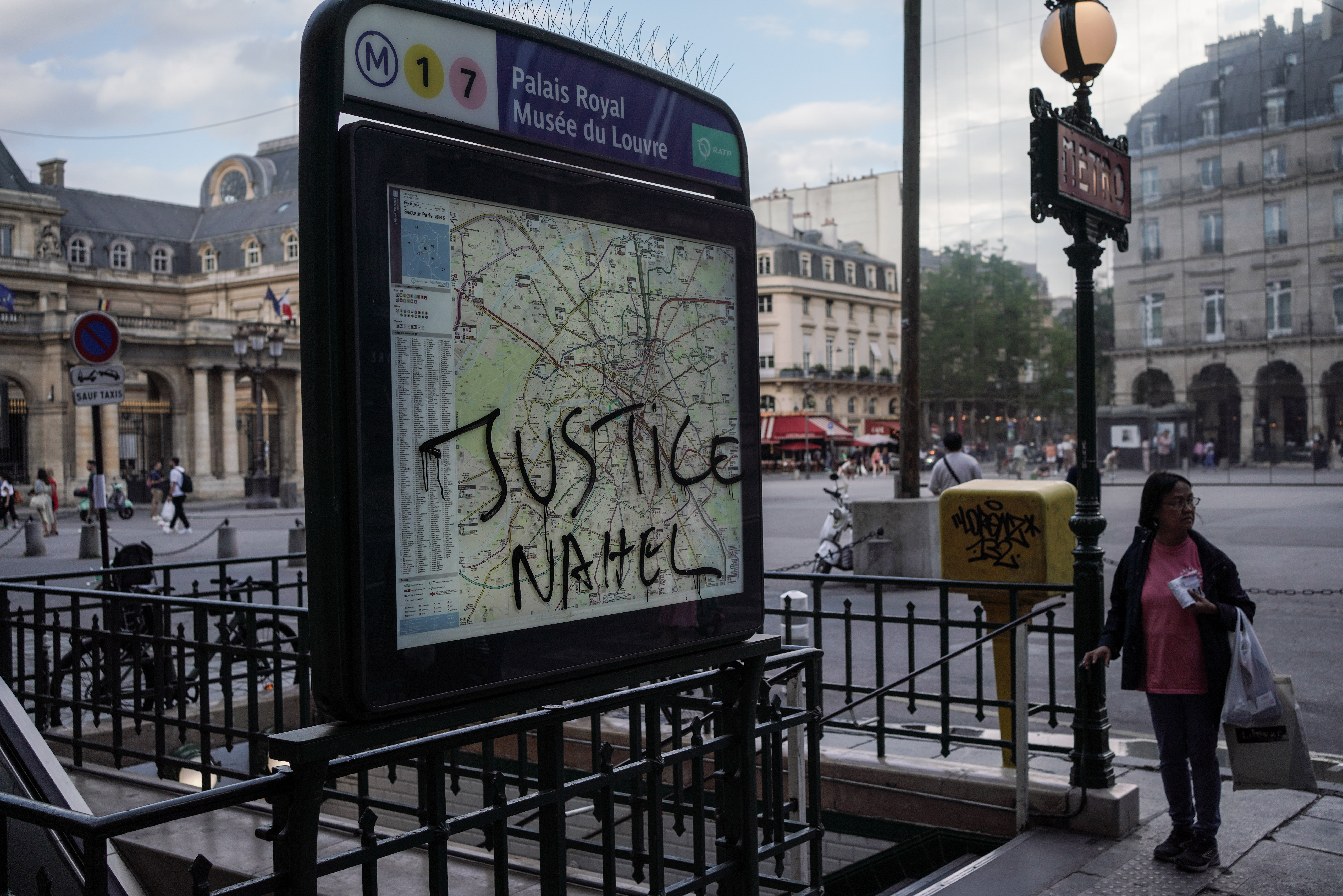 ‘Justice Nahel’ is scrawled the Palais Royal Musee du Louvre metro sign on 2 July 2023 in Paris, France