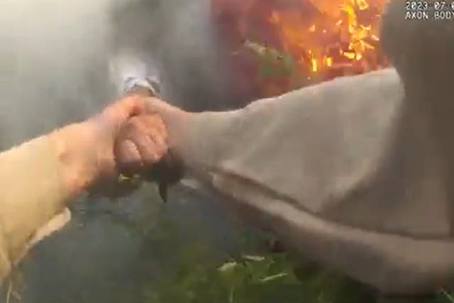 <p>Bodycam footage shows a Georgia sheriff’s deputy pulling a woman out of a burning car. Screengrab</p>
