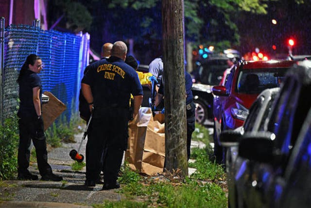 <p>Police place a rifle in a bag on the scene of a shooting on 3 July 2023 in Philadelphia, Pennsylvania</p>
