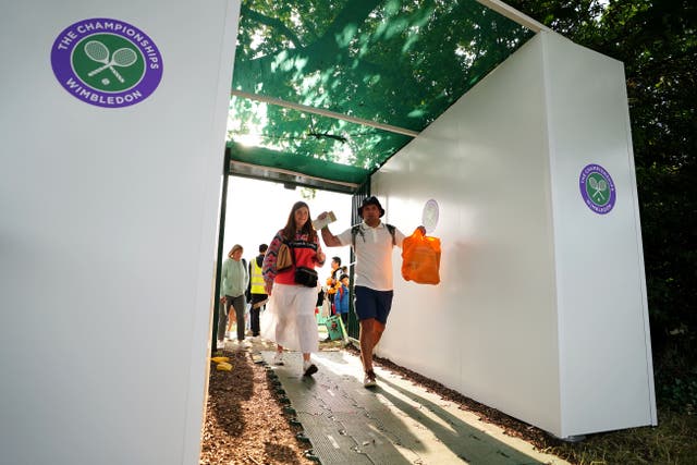 Tennis fans enter the grounds of Wimbledon after obtaining their tickets for the day’s action (Zac Goodwin/PA)