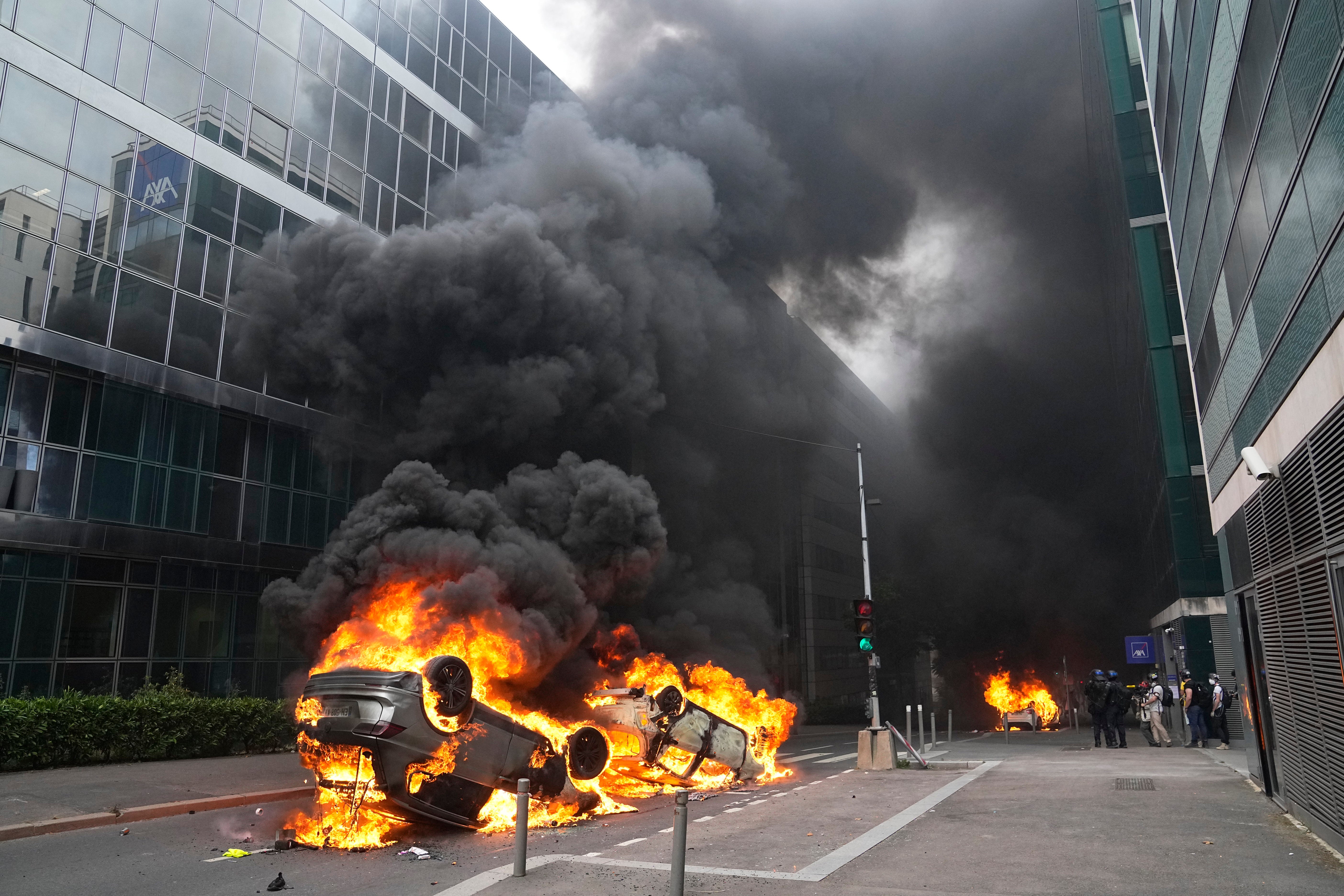 Cars burn after a march in Nanterre, outside Paris