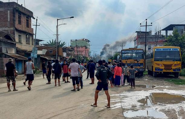 Smoke bellows from a street after a standoff between mob and security forces at Sekhon in Imphal East during ongoing ethnic violence in India’s north-eastern Manipur state on 15 June 2023