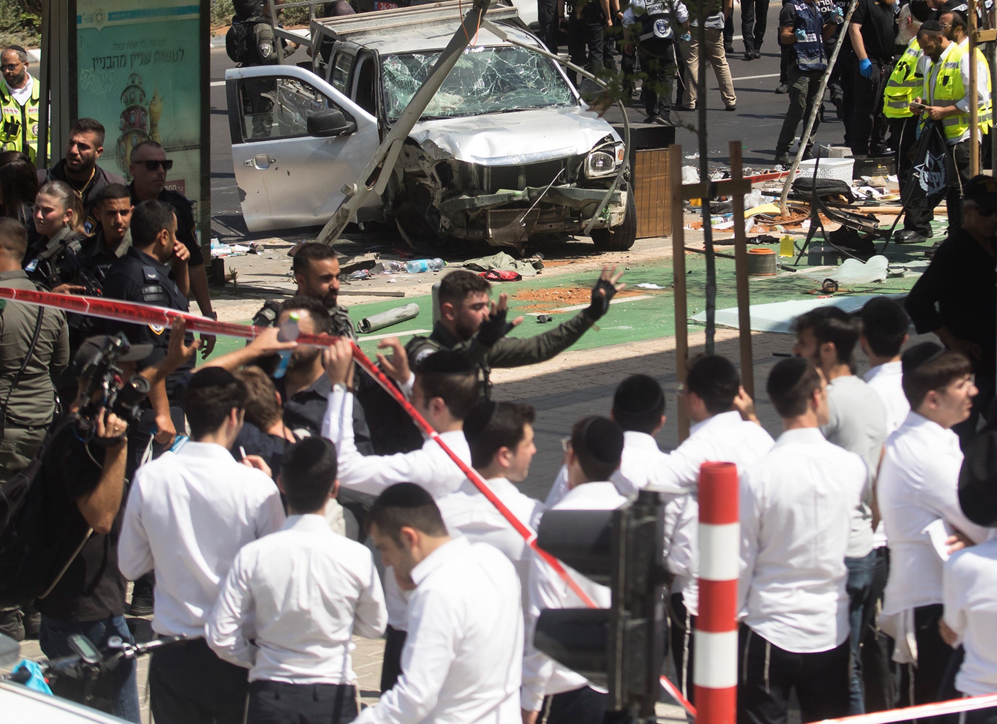 Israeli security and rescue forces examine the scene of a terror attack