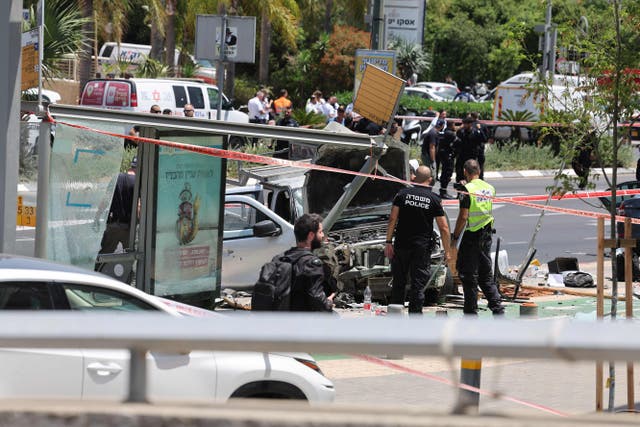 <p>Israeli security and emergency personnel work at the site of a reported car ramming attack in Tel Avi</p>