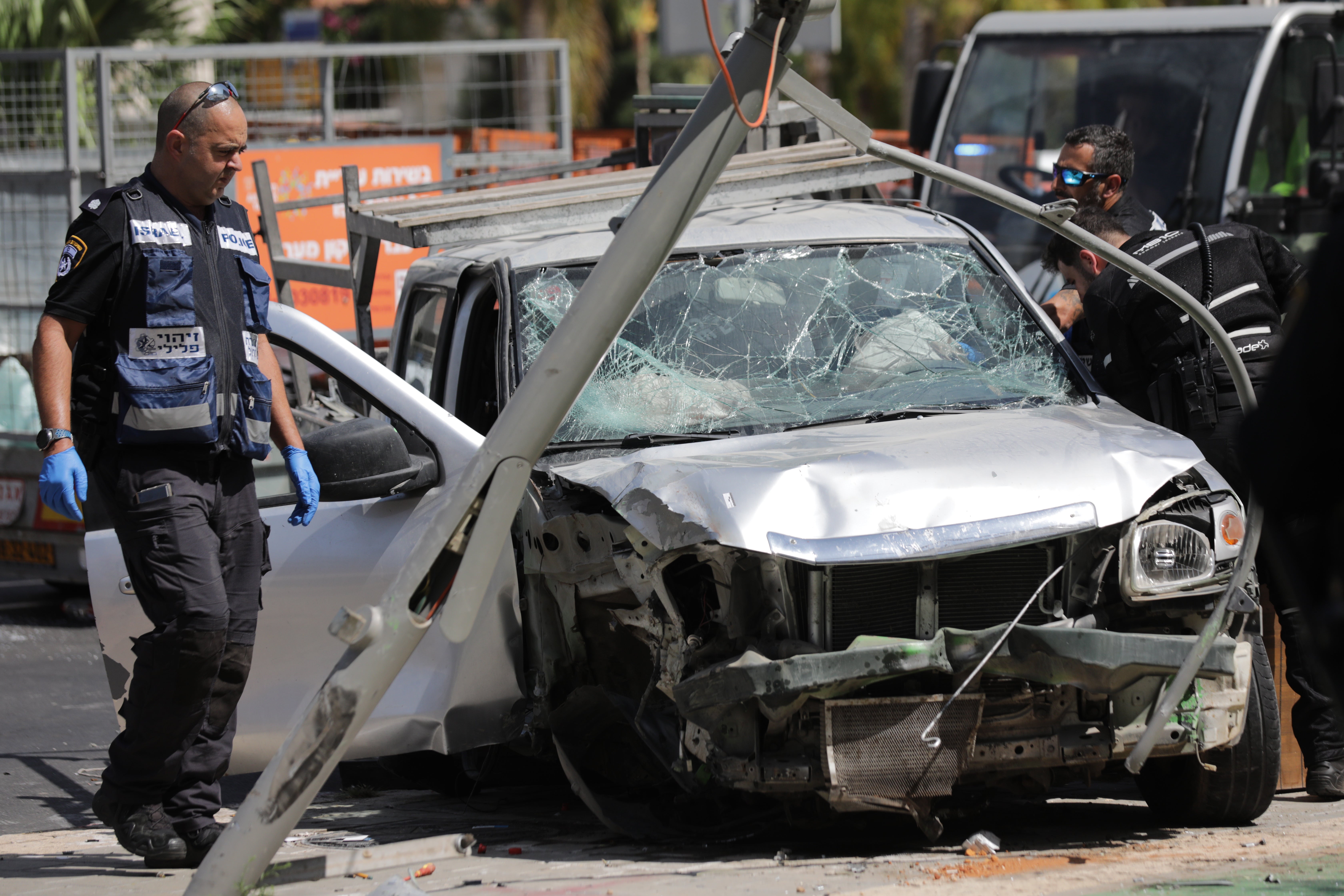 Israeli security and emergency personel inspect the scene