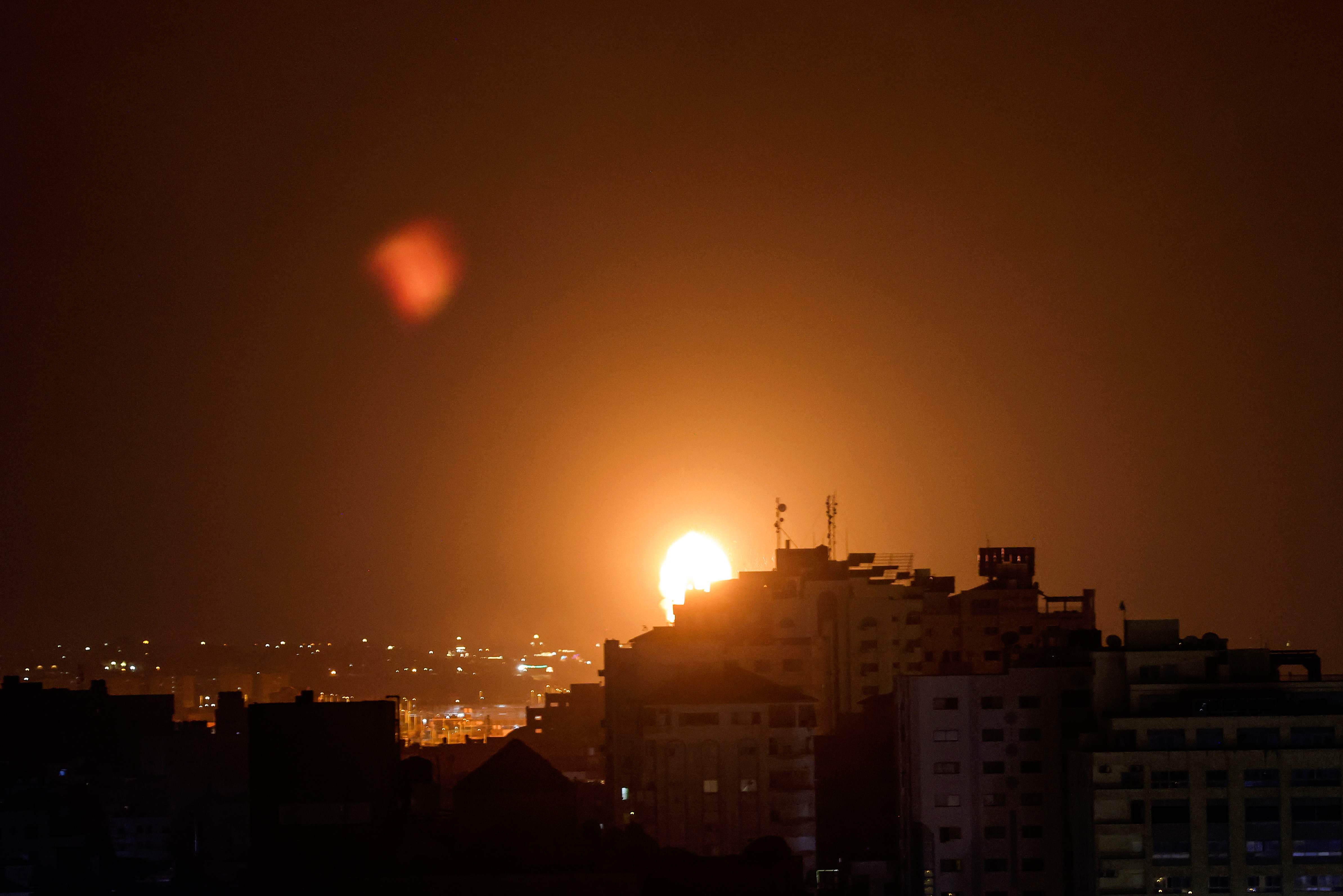 Smoke and flames rise above buildings after Israeli air airstrikes in Gaza City