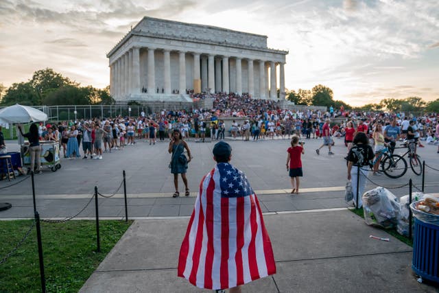 <p>An attendee wearing an American Flag as a cape approaches the Lincoln Memorial before the Independence Day fireworks display along the National Mall on 4 July 2023 in Washington, DC</p>