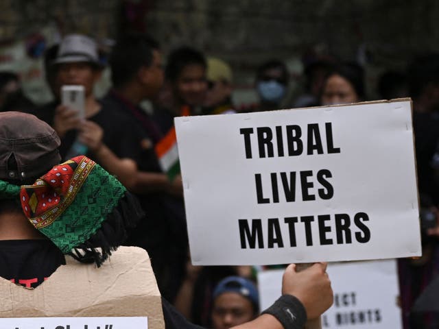 <p>Activists of the All Tribal Students Union Manipur (ATSUM) hold placards during a protest in New Delhi on 31 May 2023</p>