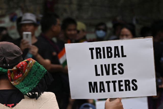 <p>Activists of the All Tribal Students Union Manipur (ATSUM) hold placards during a protest in New Delhi on 31 May 2023</p>